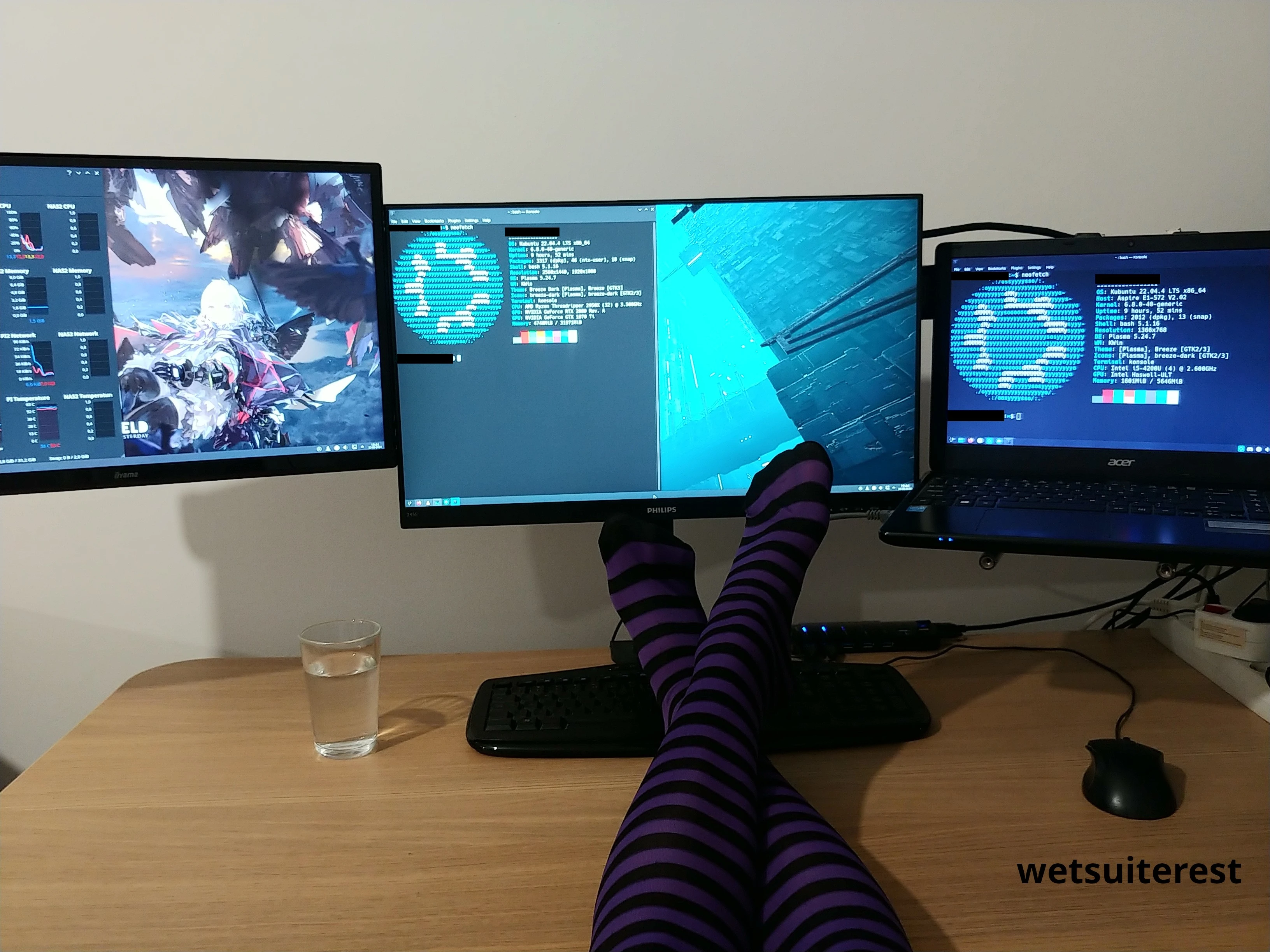 3 computer displays with pc specs, and in front there is crossed legs wearing black purple striped thigh high stockings.