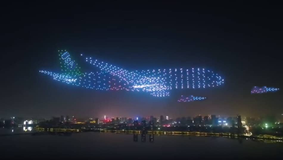 A drone light show of a plane and two missiles